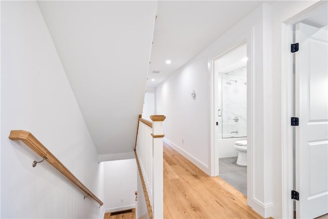 stairway with recessed lighting, baseboards, and wood finished floors