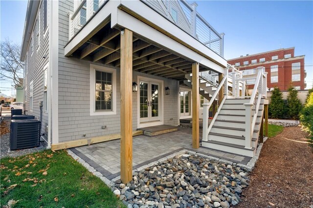 view of patio / terrace featuring cooling unit, stairs, and french doors