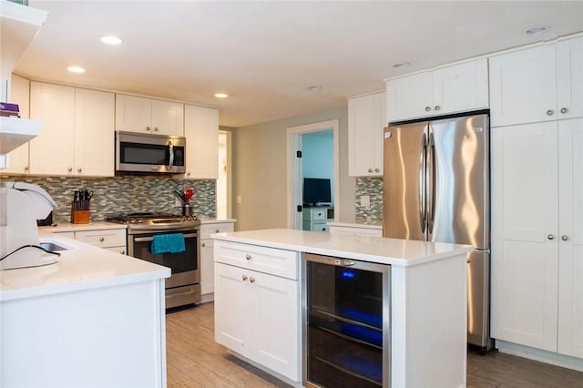 kitchen featuring wine cooler, light wood-style flooring, a center island, and stainless steel appliances