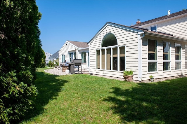 rear view of house featuring a patio and a lawn