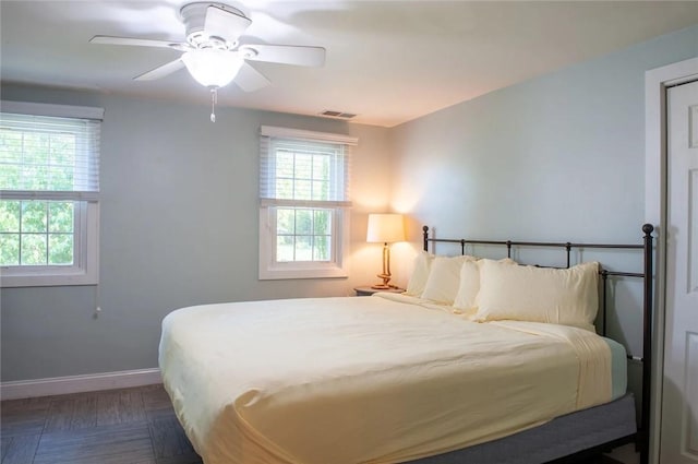 bedroom with a ceiling fan, baseboards, and visible vents