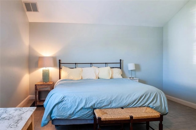 bedroom with baseboards and visible vents