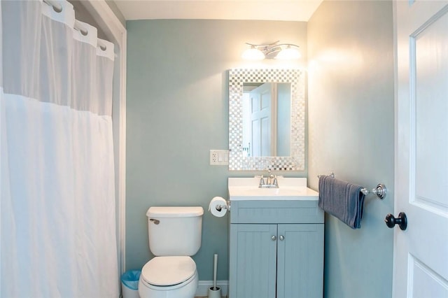 full bath with toilet, curtained shower, vanity, and baseboards