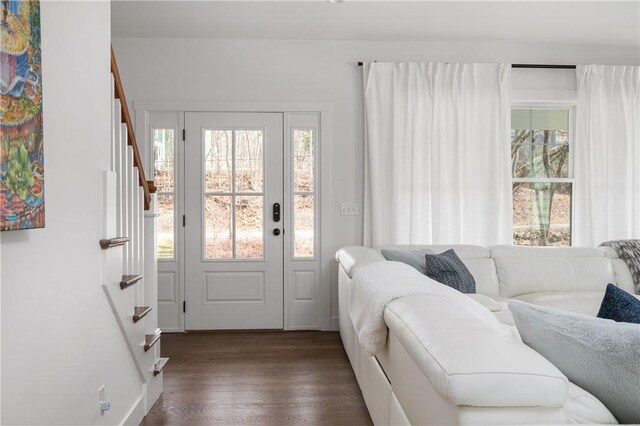 foyer featuring stairway and dark wood-style flooring