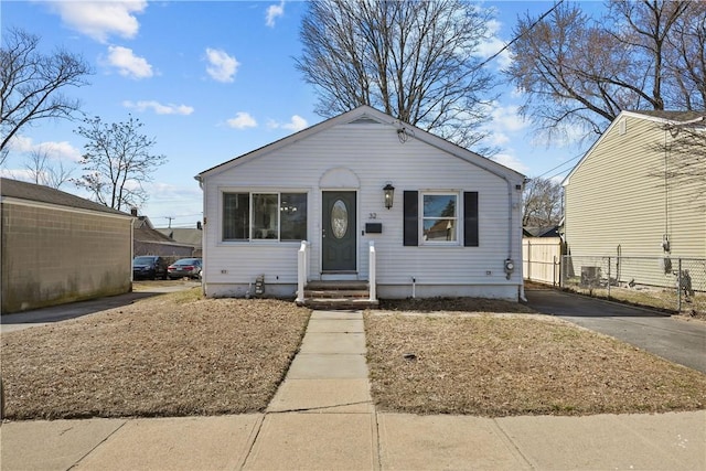 bungalow-style house with fence