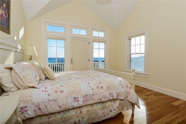 bedroom featuring high vaulted ceiling, access to outside, baseboards, and wood finished floors