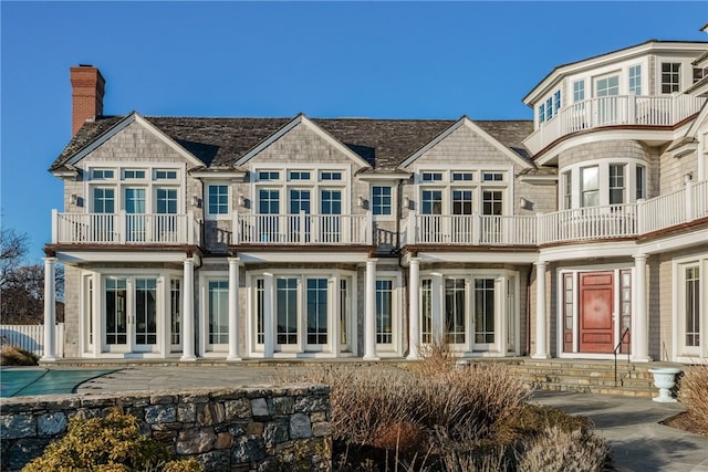 rear view of property featuring french doors and a chimney