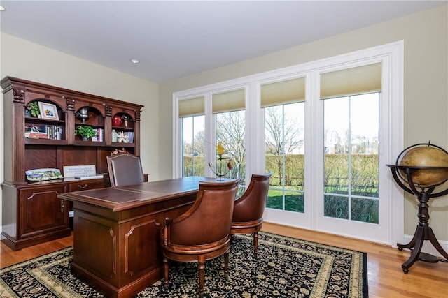 office area with light wood finished floors and recessed lighting
