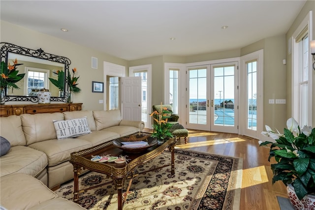 living room with wood finished floors, visible vents, and recessed lighting