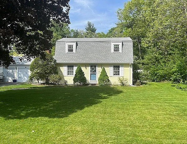 view of front of property featuring a gambrel roof and a front lawn
