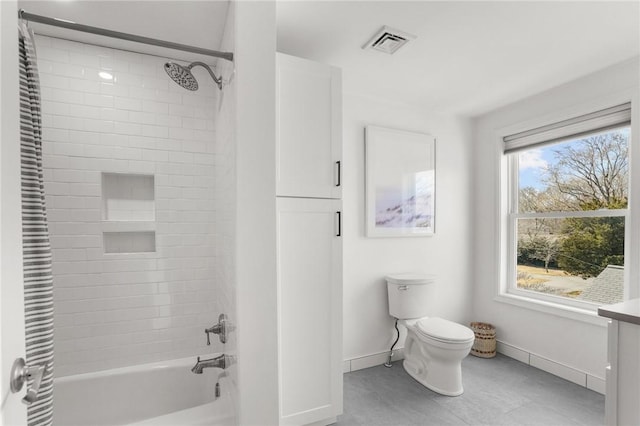 full bathroom with toilet, visible vents, shower / bath combination, and baseboards