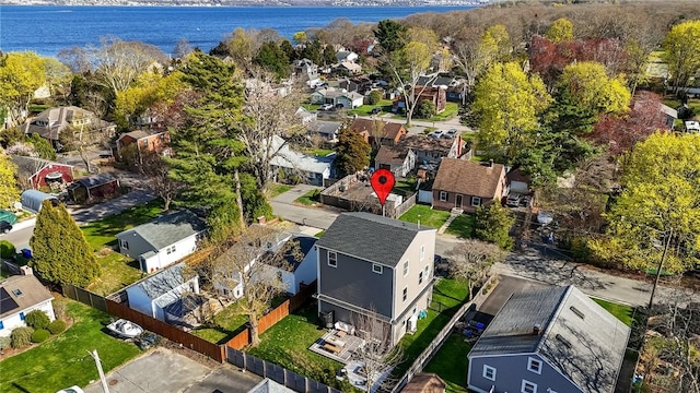drone / aerial view featuring a residential view and a water view