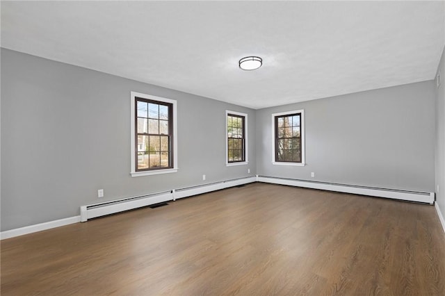 10 Eastgate Dr, Coventry, RI 02816 - unfurnished room featuring baseboard heating, baseboards, and wood finished floors