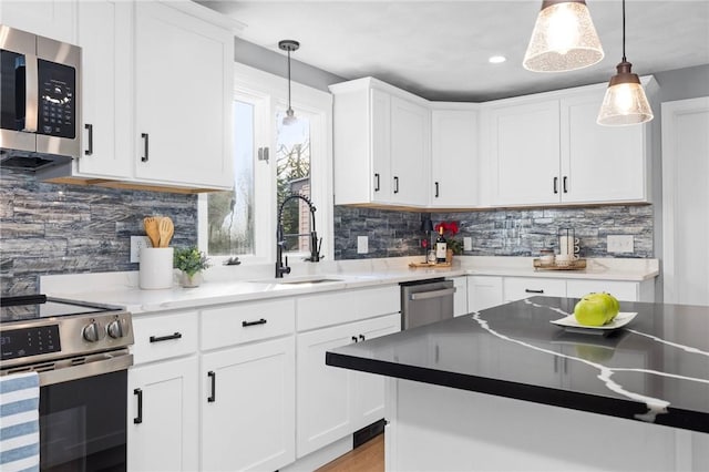 10 Eastgate Dr, Coventry, RI 02816 - kitchen with tasteful backsplash, white cabinetry, stainless steel appliances, and a sink