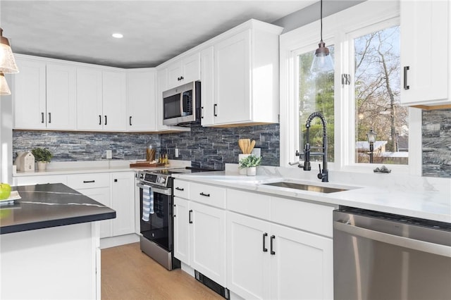 10 Eastgate Dr, Coventry, RI 02816 - kitchen featuring decorative backsplash, a sink, white cabinetry, and appliances with stainless steel finishes