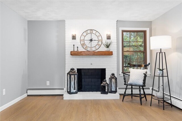 10 Eastgate Dr, Coventry, RI 02816 - living area with a fireplace, a baseboard radiator, wood finished floors, and baseboards