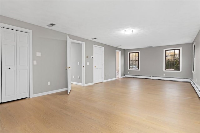 10 Eastgate Dr, Coventry, RI 02816 - unfurnished living room featuring a baseboard radiator, light wood-style flooring, visible vents, and baseboards