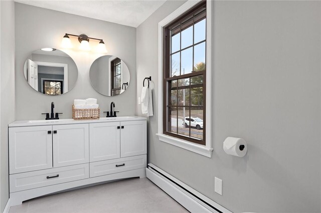 10 Eastgate Dr, Coventry, RI 02816 - bathroom featuring double vanity, baseboard heating, and a sink