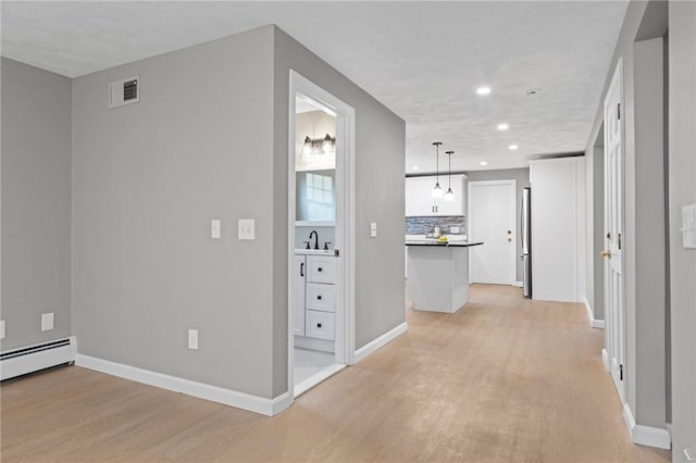 10 Eastgate Dr, Coventry, RI 02816 - hallway with recessed lighting, visible vents, a sink, light wood-type flooring, and baseboards
