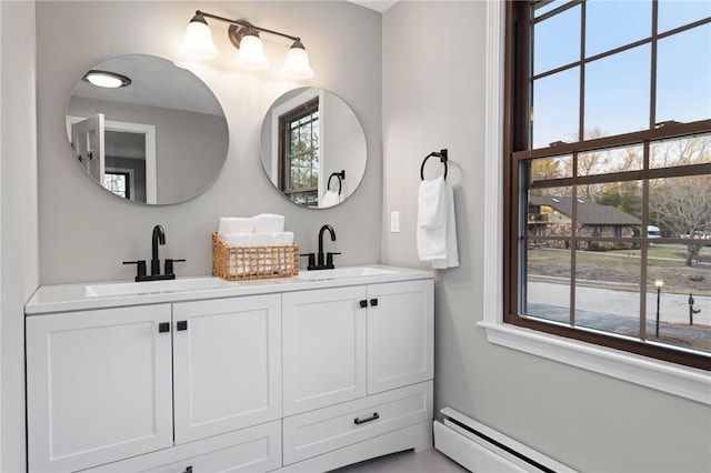10 Eastgate Dr, Coventry, RI 02816 - bathroom featuring a baseboard radiator, a healthy amount of sunlight, and a sink