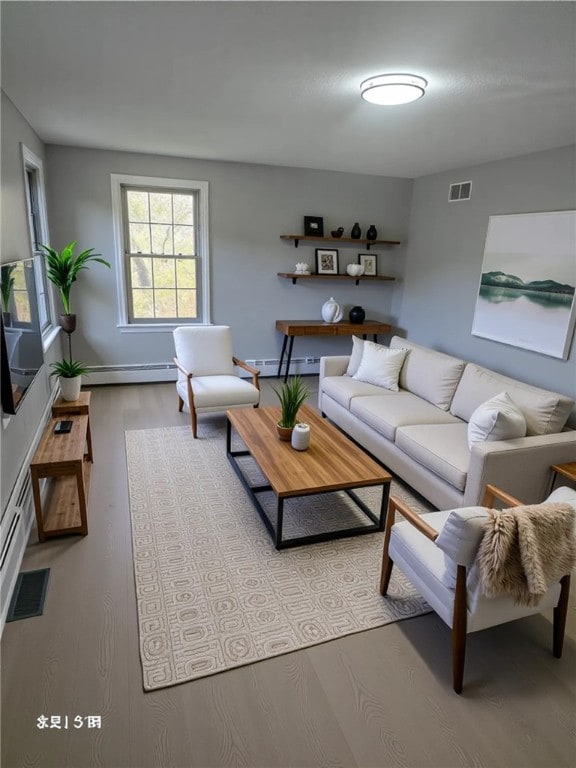 10 Eastgate Dr, Coventry, RI 02816 - living room featuring a baseboard radiator, visible vents, light wood-style flooring, and baseboards