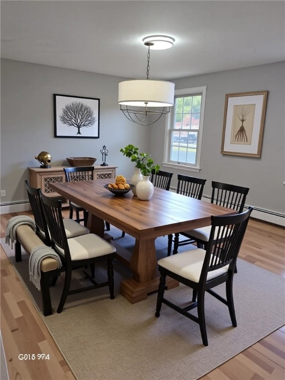 10 Eastgate Dr, Coventry, RI 02816 - dining area with light wood finished floors, baseboards, and a baseboard radiator