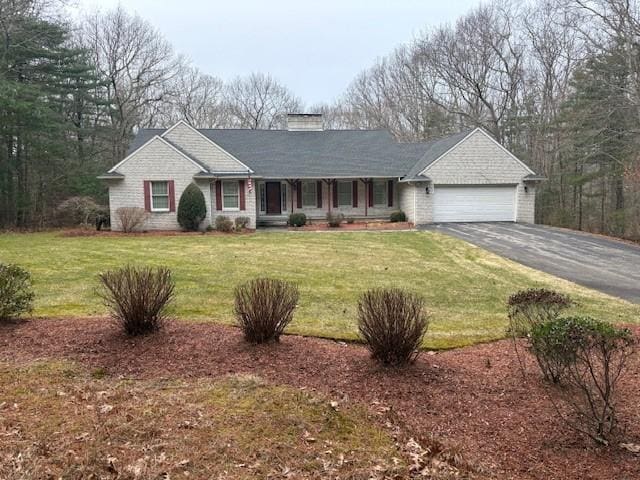 ranch-style house with aphalt driveway, a front yard, and a garage