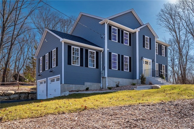 view of front of house featuring a garage and a front lawn