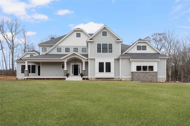 105 Princess Pine Dr, East Greenwich, RI 02818 - view of front of house with a front yard, board and batten siding, and roof with shingles