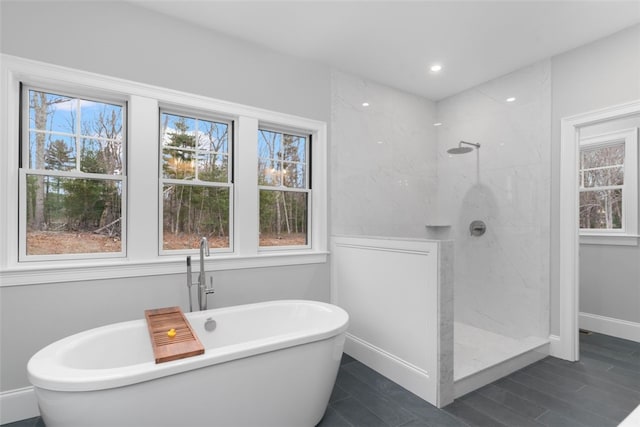 105 Princess Pine Dr, East Greenwich, RI 02818 - bathroom with baseboards, plenty of natural light, a freestanding bath, and walk in shower