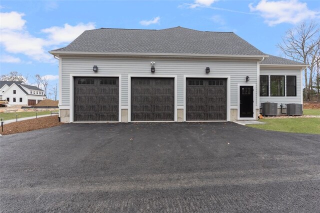 105 Princess Pine Dr, East Greenwich, RI 02818 - view of front of house with cooling unit, a garage, and roof with shingles