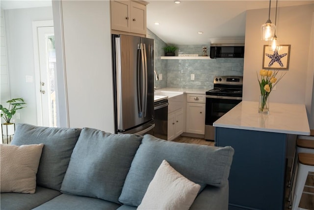 kitchen featuring decorative backsplash, open shelves, appliances with stainless steel finishes, a kitchen bar, and open floor plan
