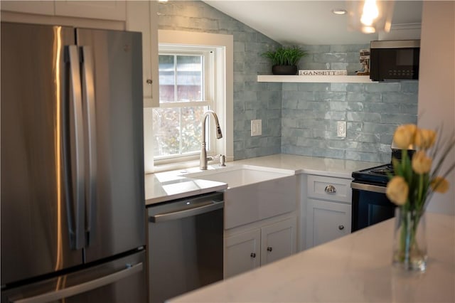 kitchen with tasteful backsplash, stainless steel appliances, open shelves, and light countertops