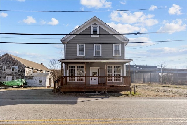 view of front of home with covered porch and an outdoor structure