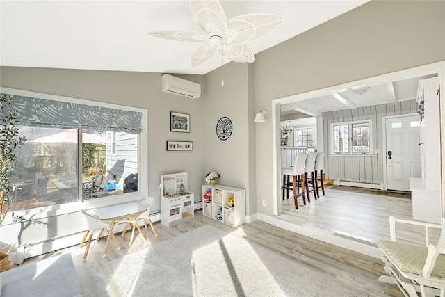 interior space with an AC wall unit, a healthy amount of sunlight, vaulted ceiling, and baseboard heating