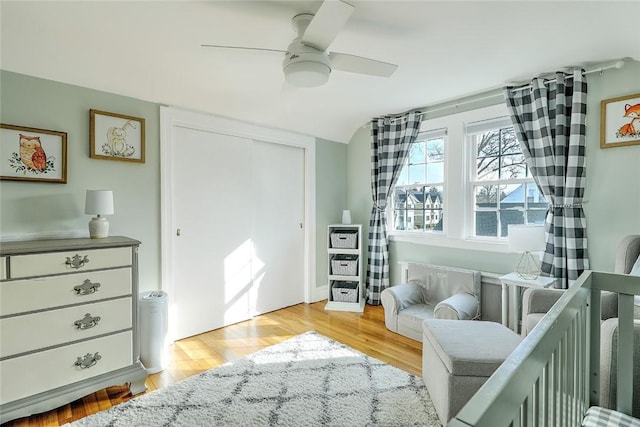 bedroom featuring a closet, light wood-style floors, and ceiling fan