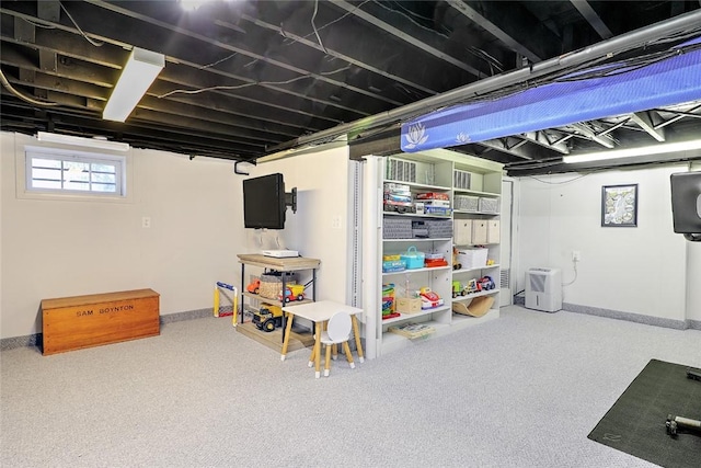 below grade area featuring baseboards and carpet