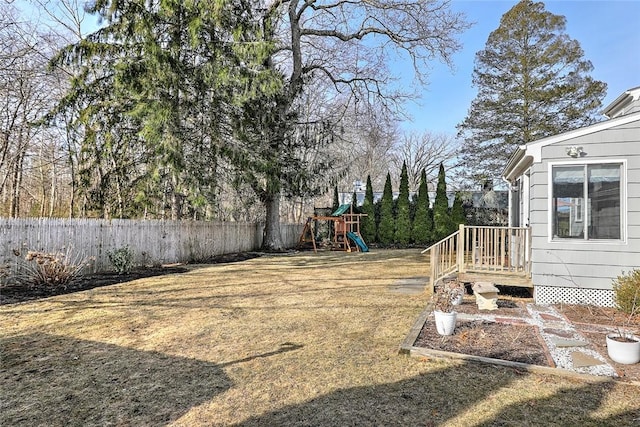 view of yard featuring a playground and fence
