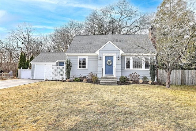 view of front of property with a front yard, concrete driveway, a garage, and fence