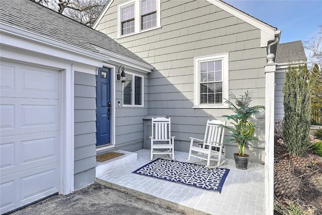 entrance to property with roof with shingles