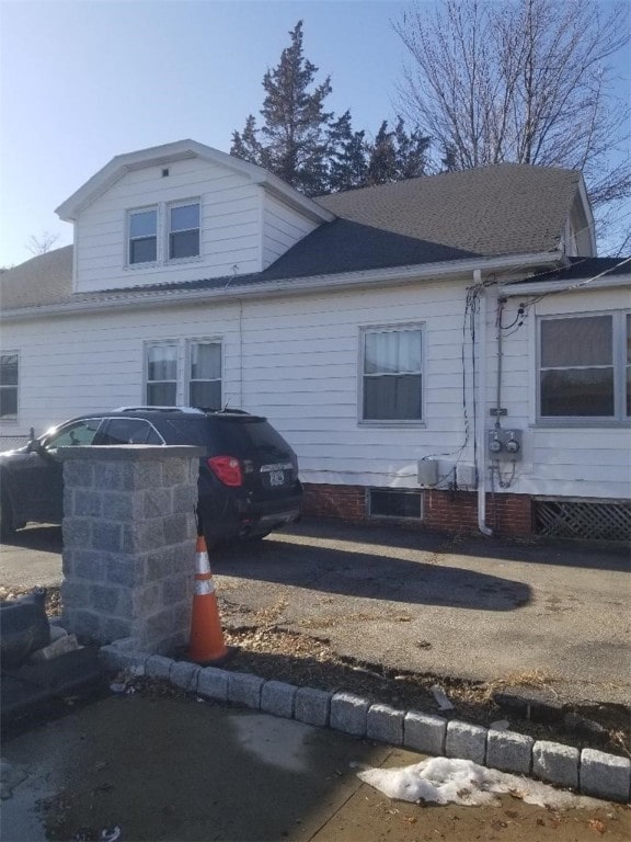 exterior space with a shingled roof