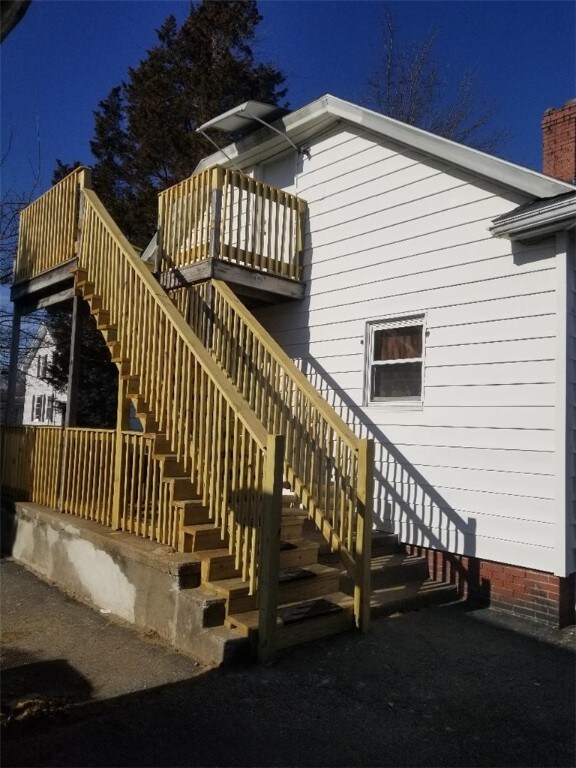 back of property featuring stairs