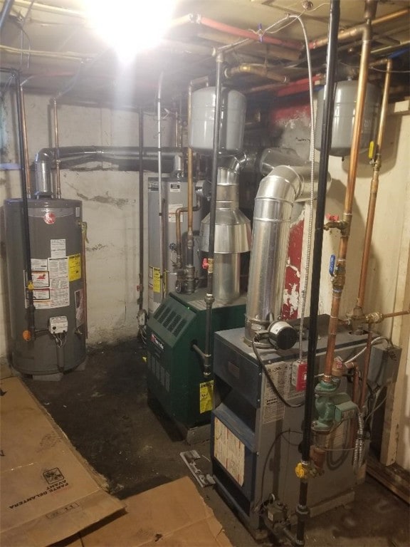 utility room featuring a heating unit and gas water heater