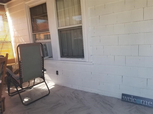 interior space with concrete block wall