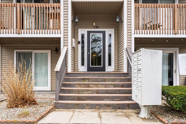 view of exterior entry featuring a balcony
