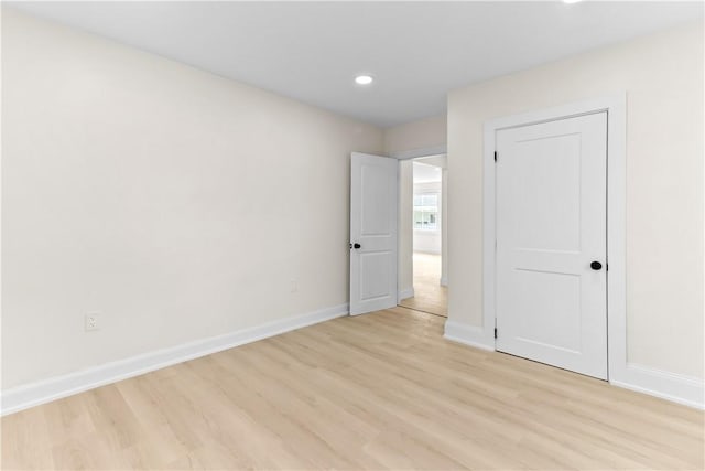unfurnished bedroom with baseboards, light wood-style flooring, and recessed lighting
