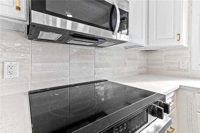 kitchen with white cabinetry, light countertops, decorative backsplash, and appliances with stainless steel finishes
