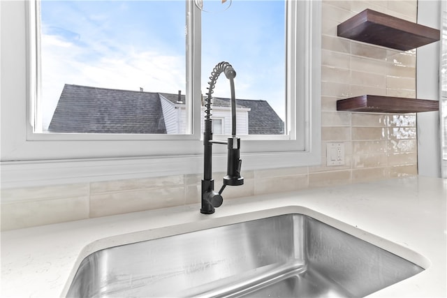 details featuring decorative backsplash and a sink