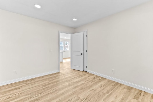 unfurnished room featuring baseboards, light wood-type flooring, and recessed lighting