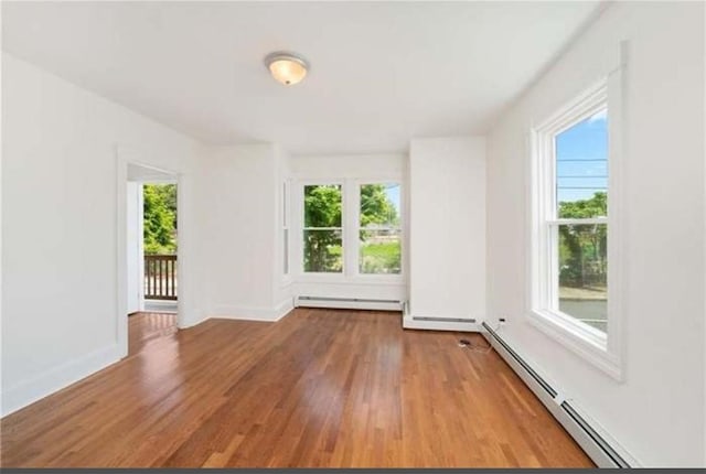 57 School St, East Providence, RI 02914 - empty room featuring a baseboard radiator, baseboard heating, baseboards, and wood finished floors